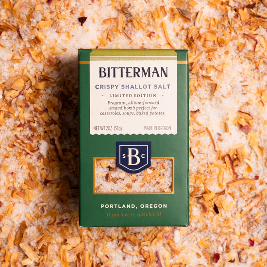 Bitterman's Crispy Shallot Salt in a green box on top of a bed of shallot salt