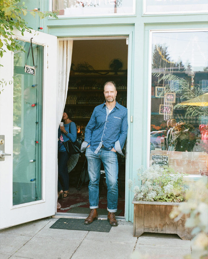 Mark Bitterman leaning against front door at mississippi shop