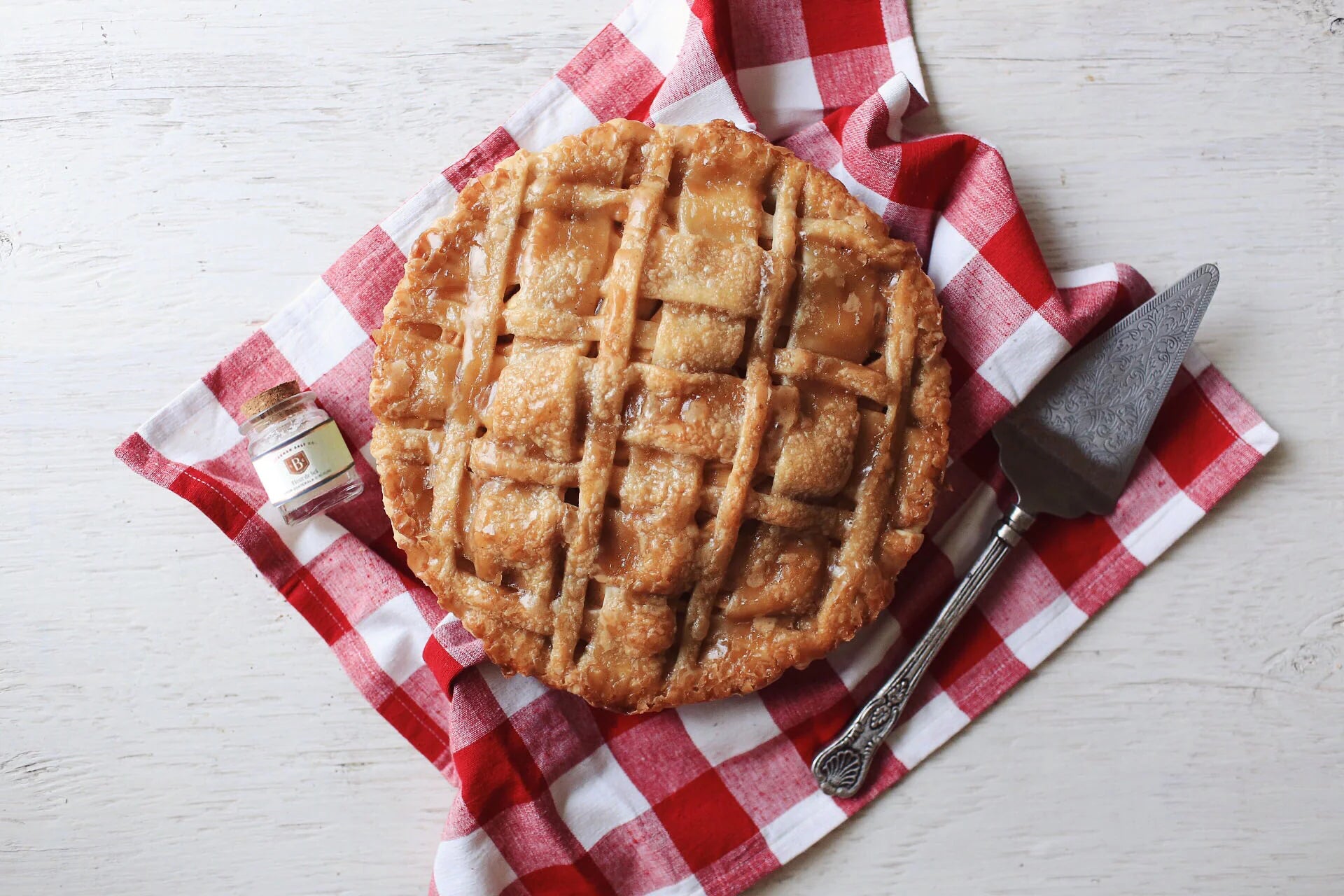 Homemade apple pie with fleur de sel, red and white checker towel in background
