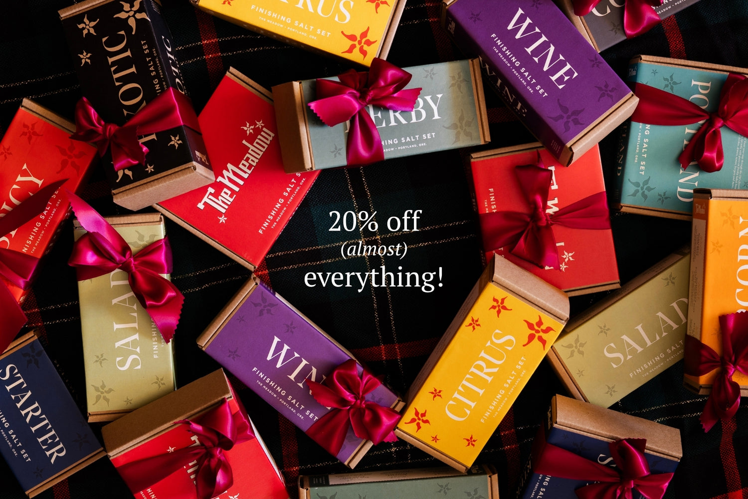 Assorted gift boxes with colorful ribbons and a sale banner in the center.