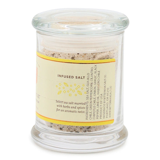Glass jar with chili lime salt mix and label on a white background