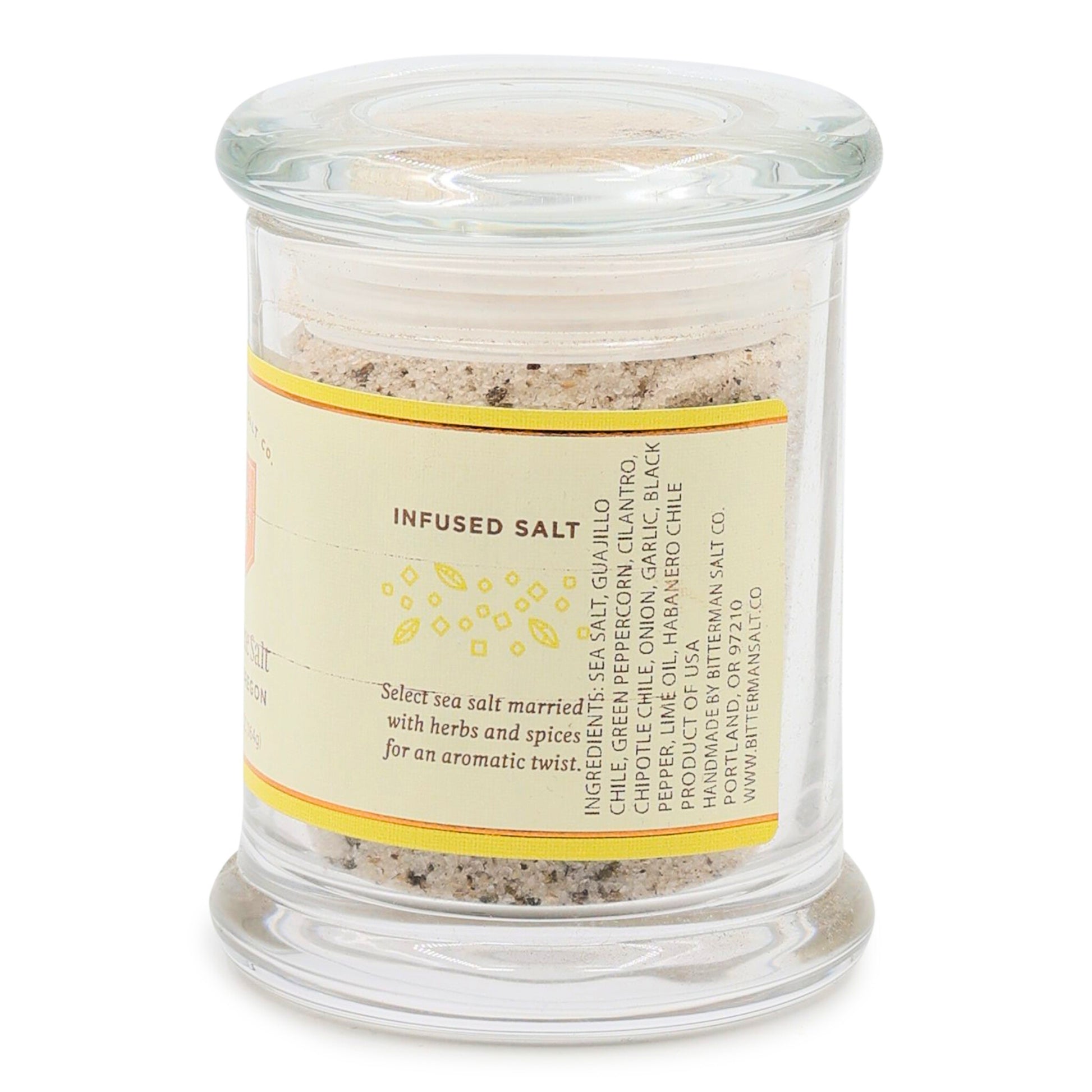 Glass jar with chili lime salt mix and label on a white background