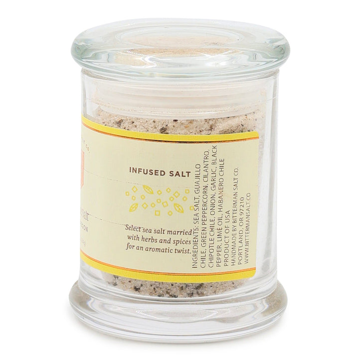 Glass jar with chili lime salt mix and label on a white background