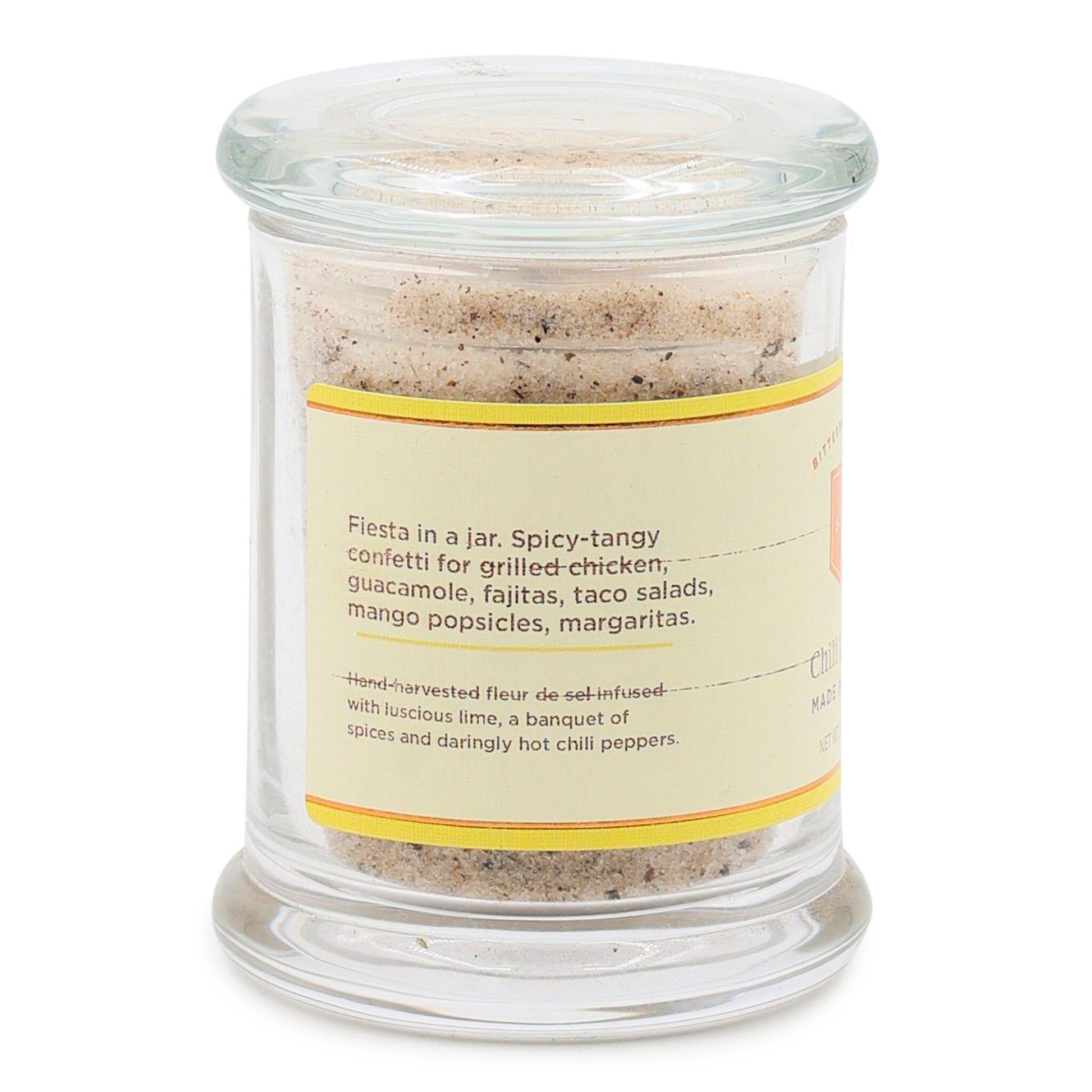 Glass jar with chili lime salt mix and label on a white background