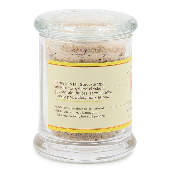Glass jar with chili lime salt mix and label on a white background