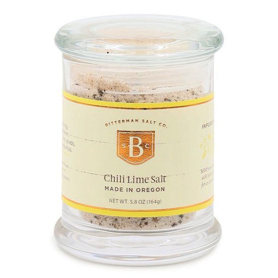 Glass jar of Chili Lime Salt with a label on a white background