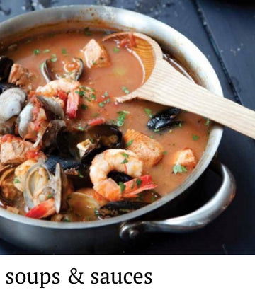 Seafood soup in a pot with a wooden spoon, labeled 'soups & sauces'.