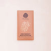 Coconut Macaroon chocolate bar packaging with 'Crow & Moss Chocolatery' branding on a light pink background