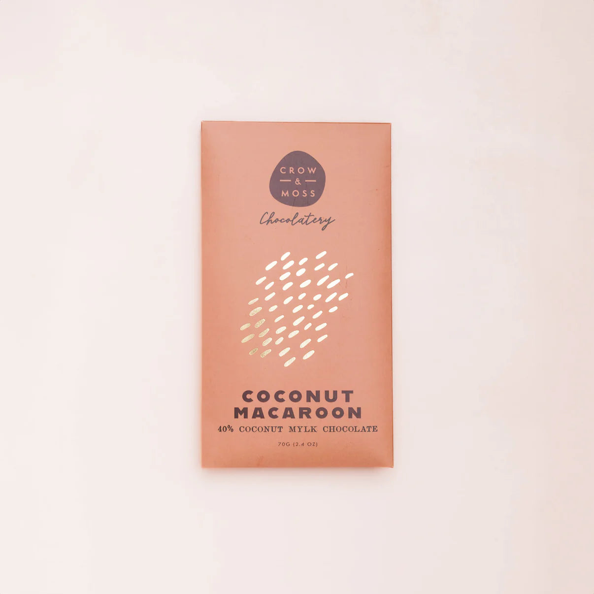 Coconut Macaroon chocolate bar packaging with 'Crow & Moss Chocolatery' branding on a light pink background