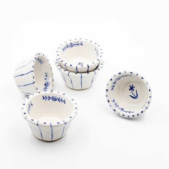 5 salt cellars on white background