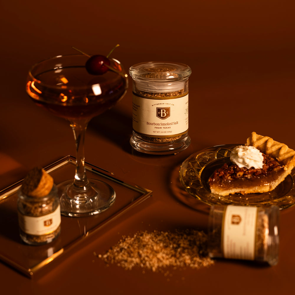bourbon smoked salt trio on brown background with pecan pie and manhattan