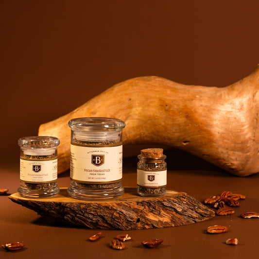 pecan smoked salt trio with wood and brown background