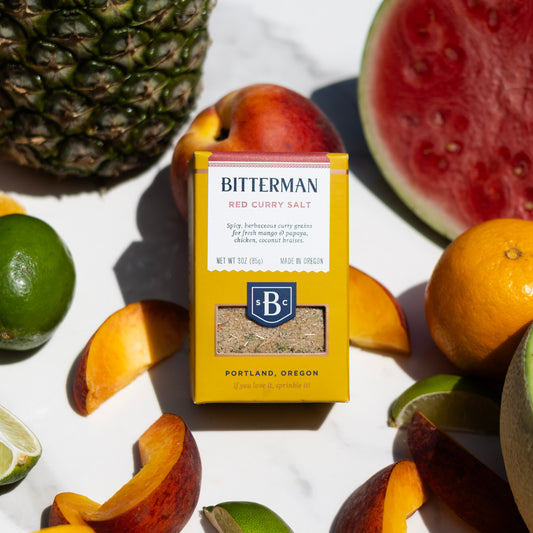 Bitterman's Red Curry Salt on marble counter with fresh fruit