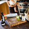 woman holding baby next to kitchen island with products
