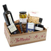 Gift basket from 'The Meadow' with various food items including a bottle of olive oil and a jar of pickles.