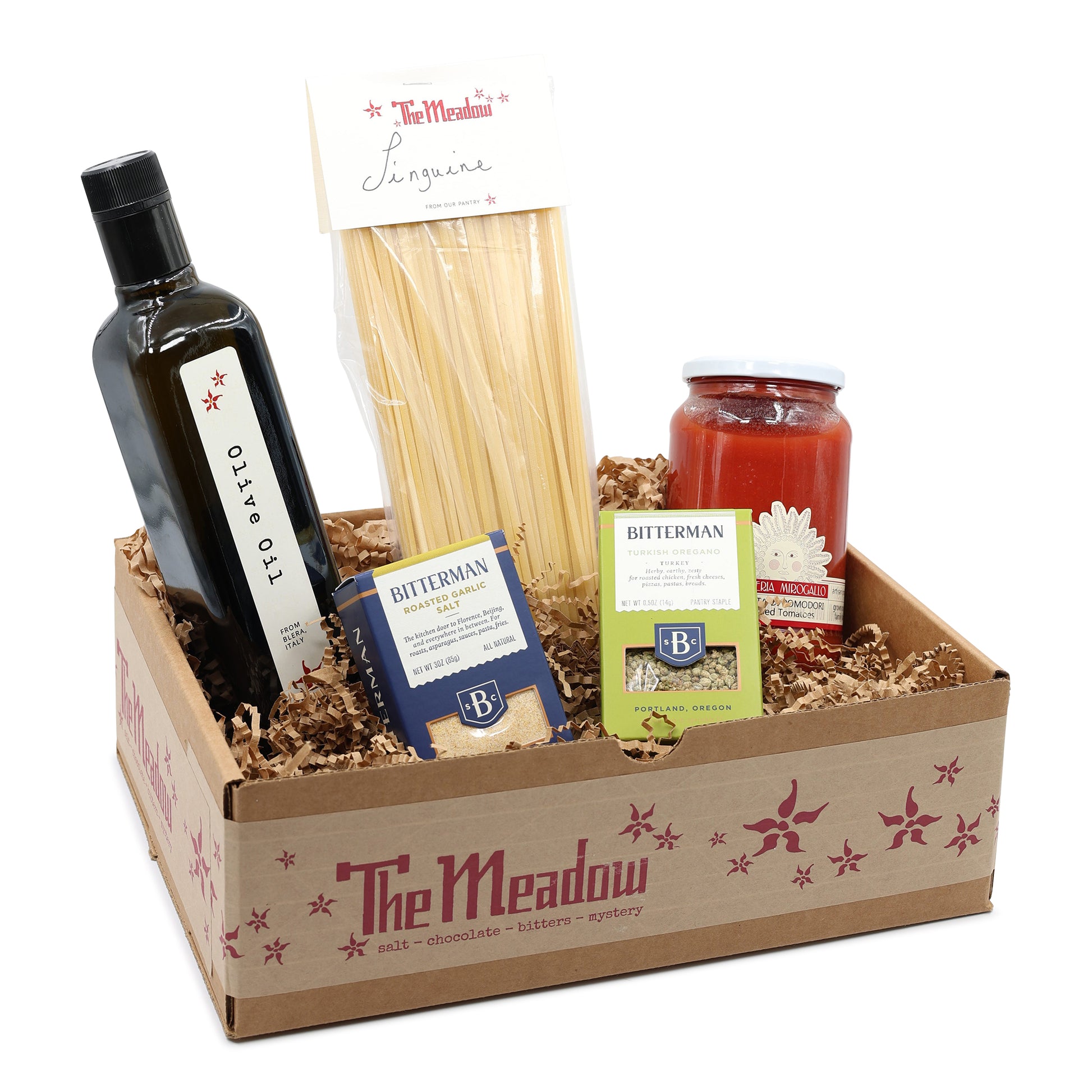 Gift box from 'The Meadow' with olive oil, pasta, and other items on a white background
