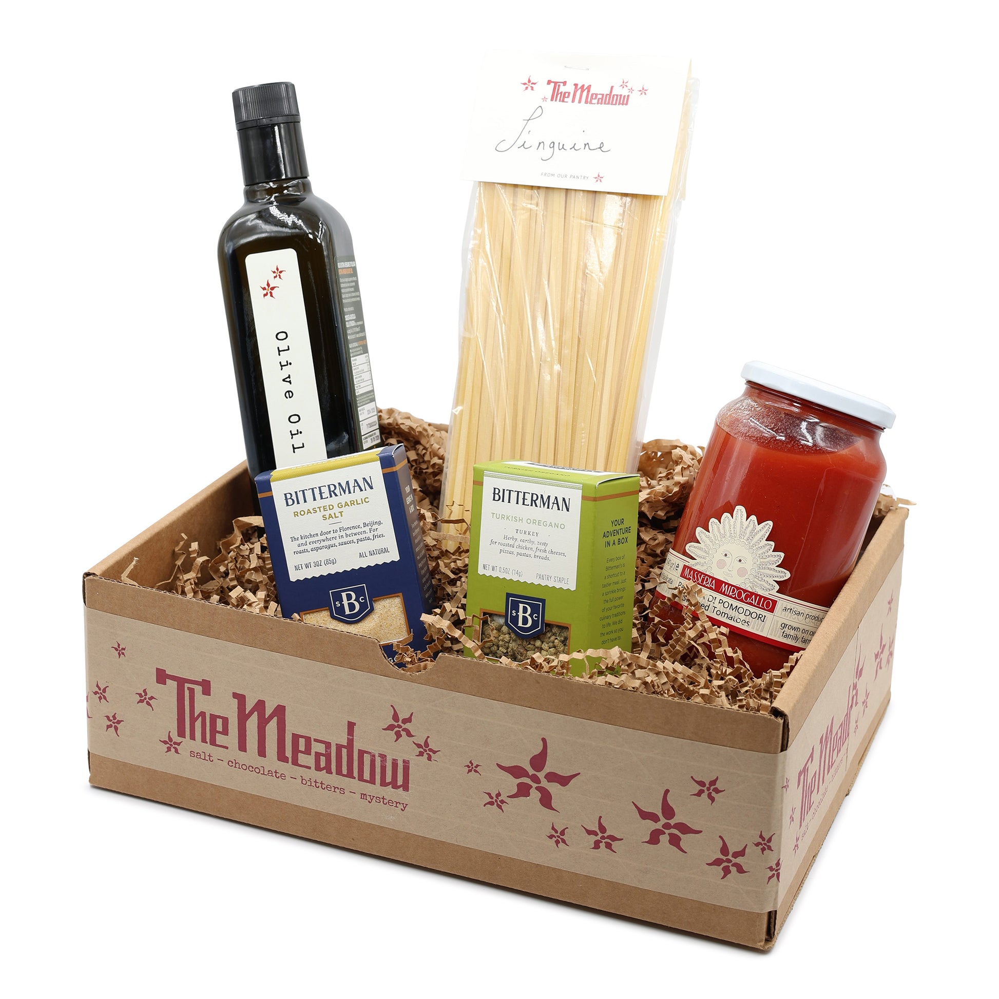 Gift box from 'The Meadow' with olive oil, pasta, and other items on a white background