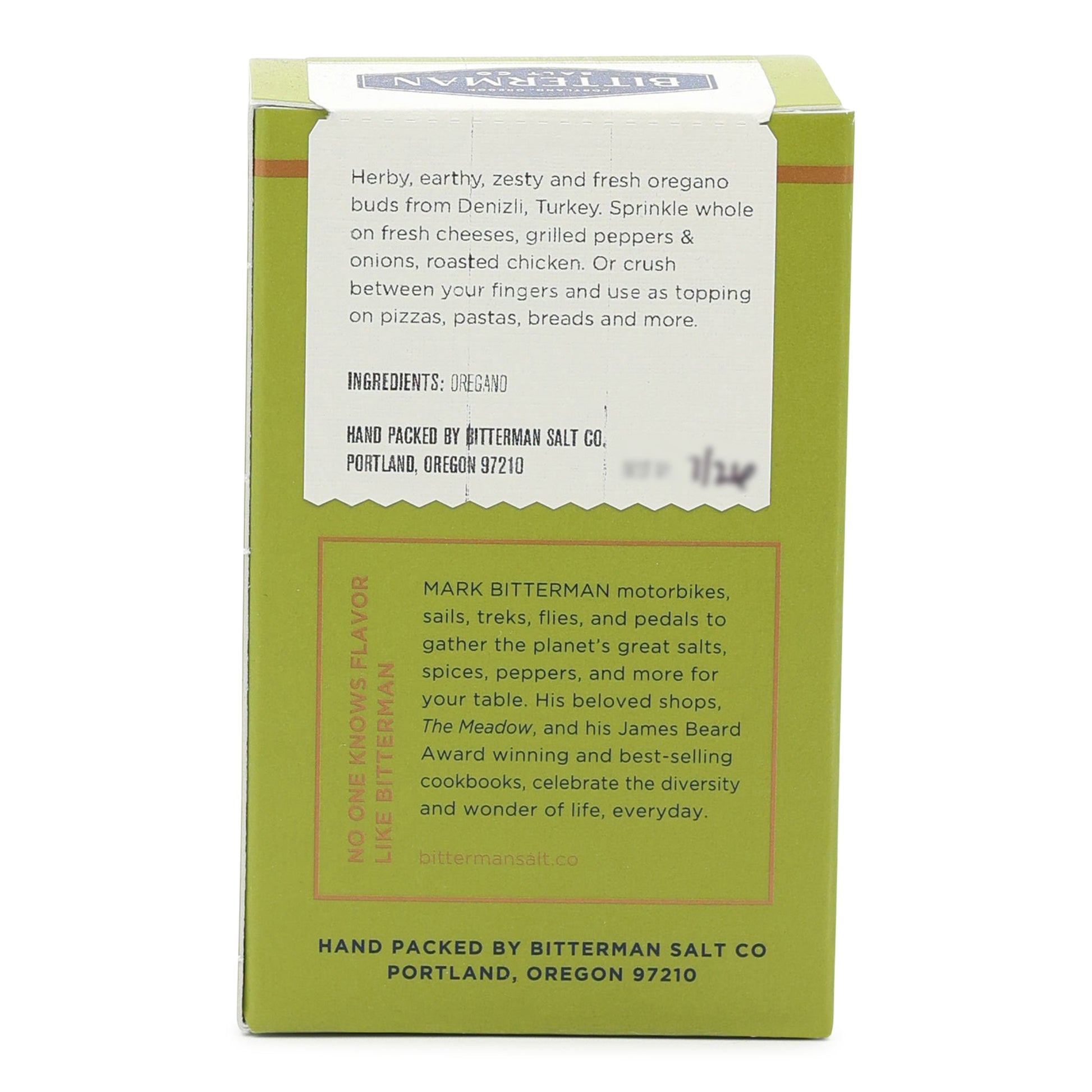 Green package with white label containing text and branding on a white background