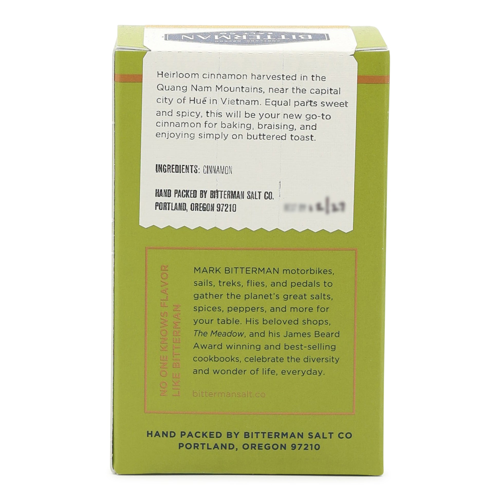Green box with white label containing Bitterman's cinnamon, featuring text about the product and brand.