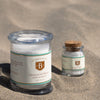 Two jars of Bitterman's salt on a sandy surface