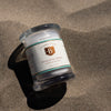 Jar of Oaxacan Sal Blanca on a sandy surface