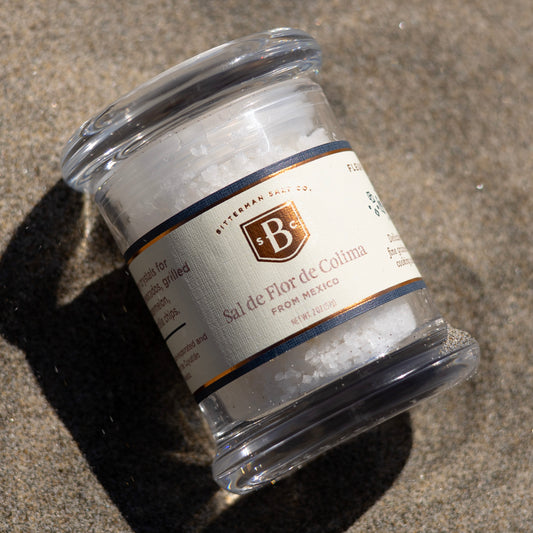 Jar of salt with a label in the sand