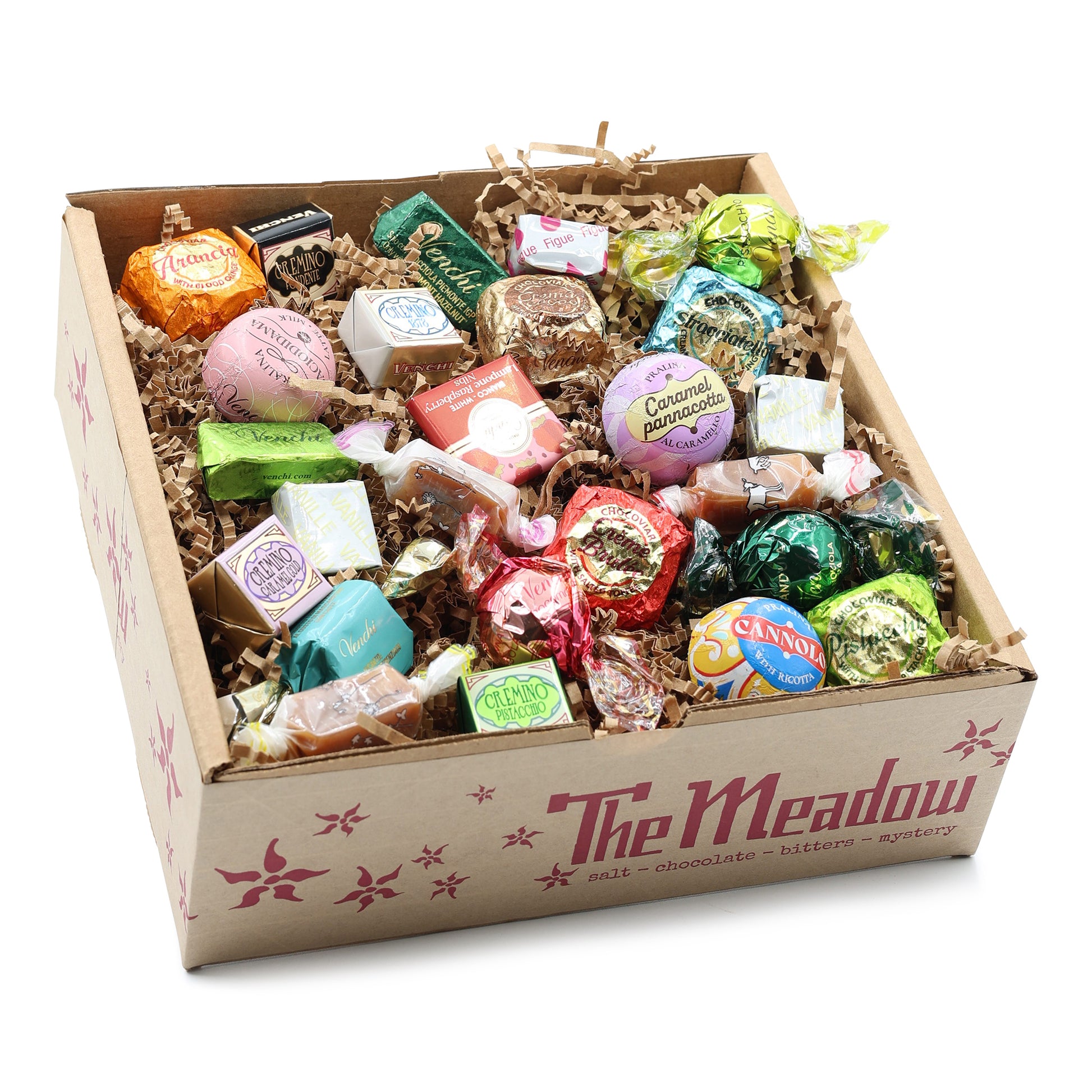 Box of assorted candies with 'The Meadow' branding on a white background
