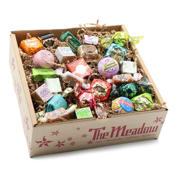Box of assorted candies with 'The Meadow' branding on a white background