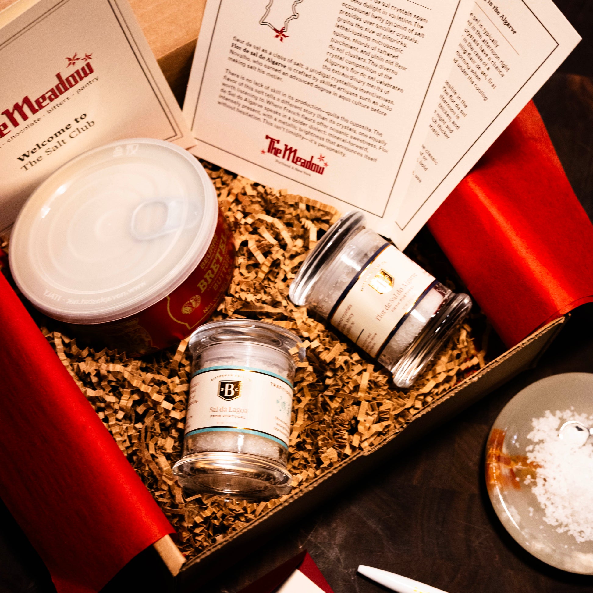 salts and papers with accessories for salt club in a box with red tissue