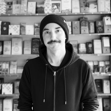 a portrait of Jason in front of the chocolate wall