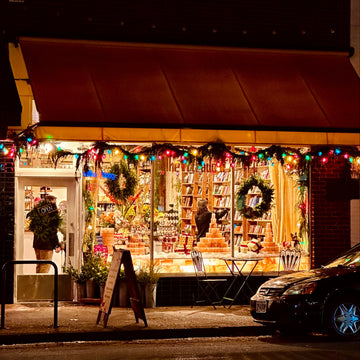 Hawthorne Christmas Storefront with festive decorations and lights at night