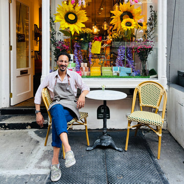 Miguel sitting outside mulberry shop
