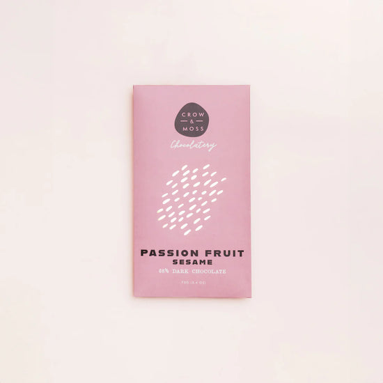 Pink chocolate packaging with 'Passion Fruit Sesame' text on a light pink background