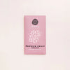 Pink chocolate packaging with 'Passion Fruit Sesame' text on a light pink background