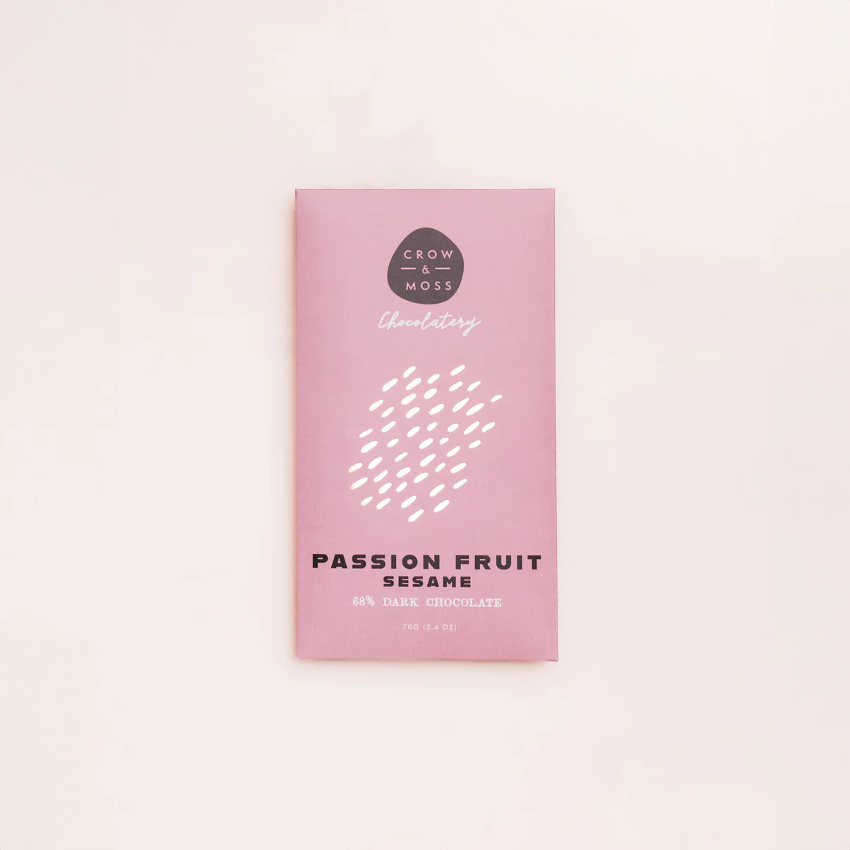Pink chocolate packaging with 'Passion Fruit Sesame' text on a light pink background