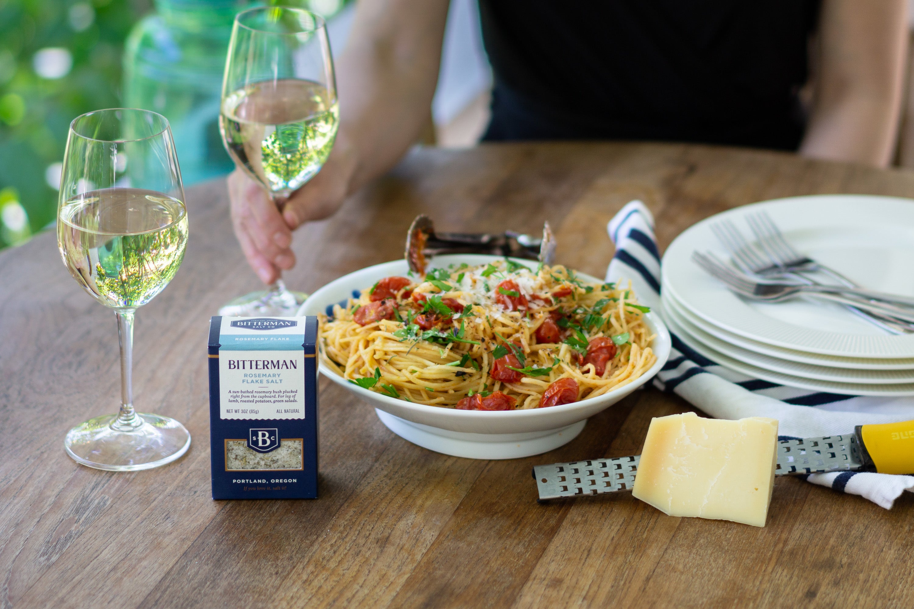 bowl of pasta with tomatoes, green beans, white wine, rosemary flake salt