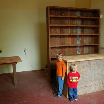The Bitterman boys standing in the mississippi shop as it was being built