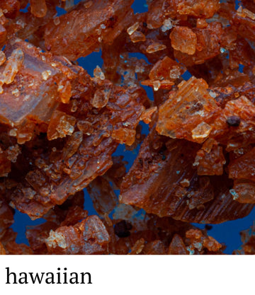 Close-up of brown sugar crystals with a blue background