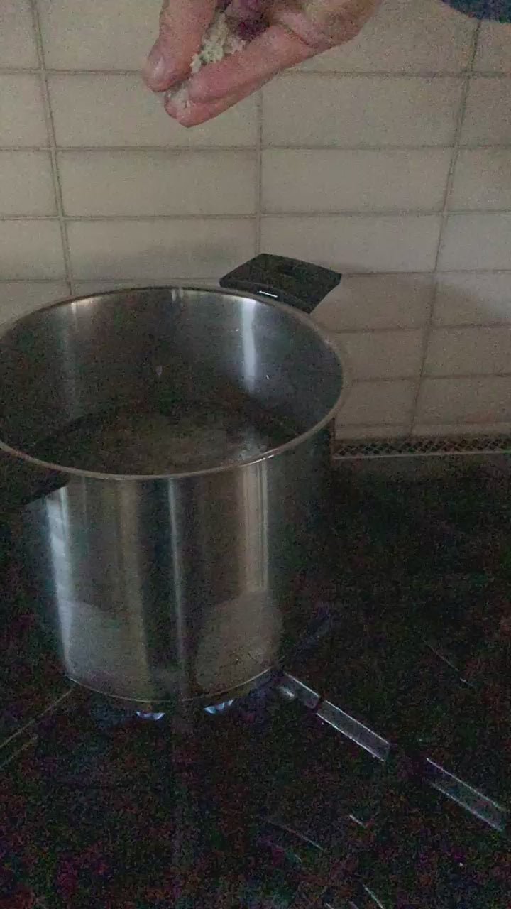 video of sel gris going into stockpot on stove